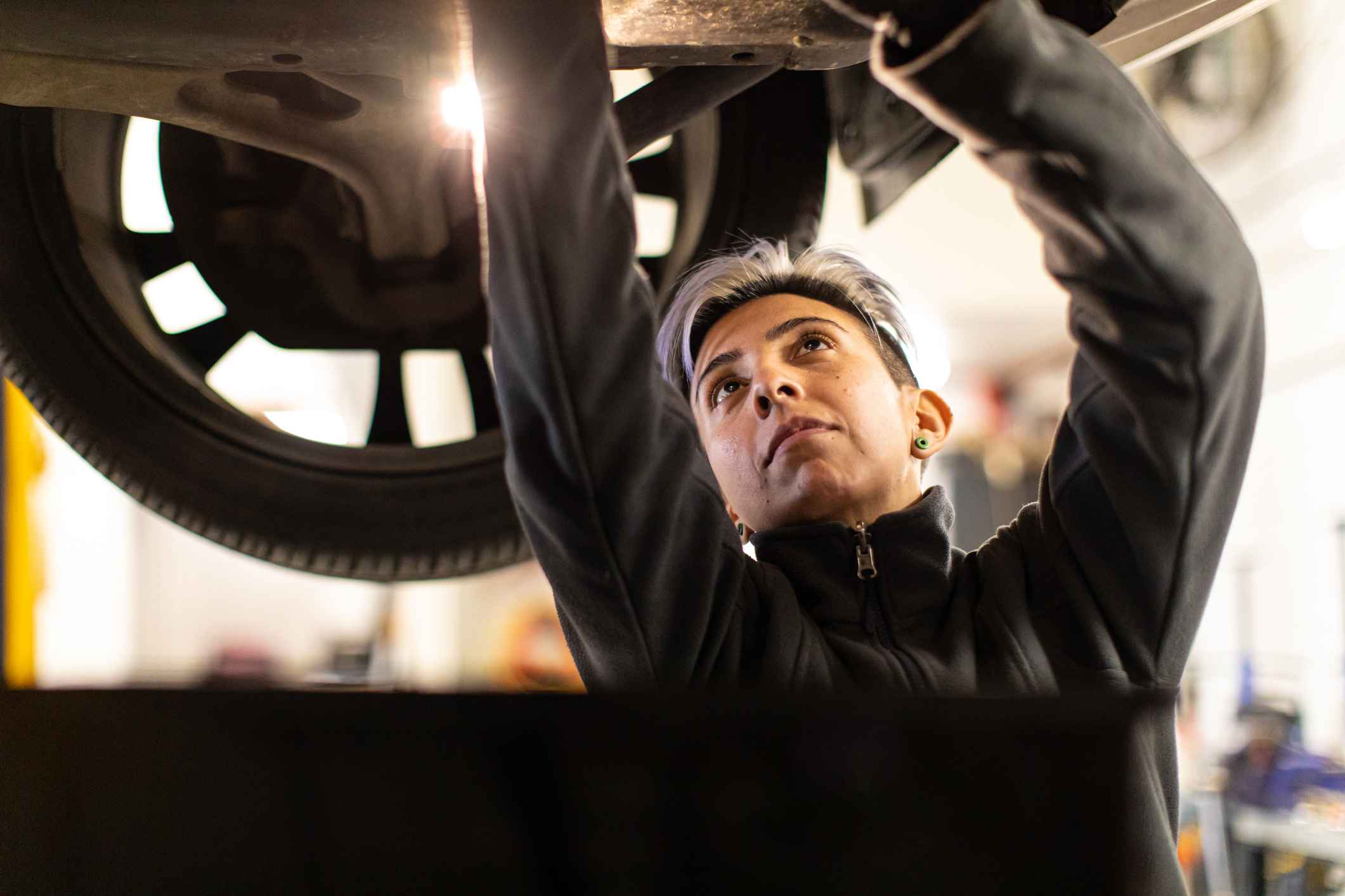 female mechanic fixing a vehicle