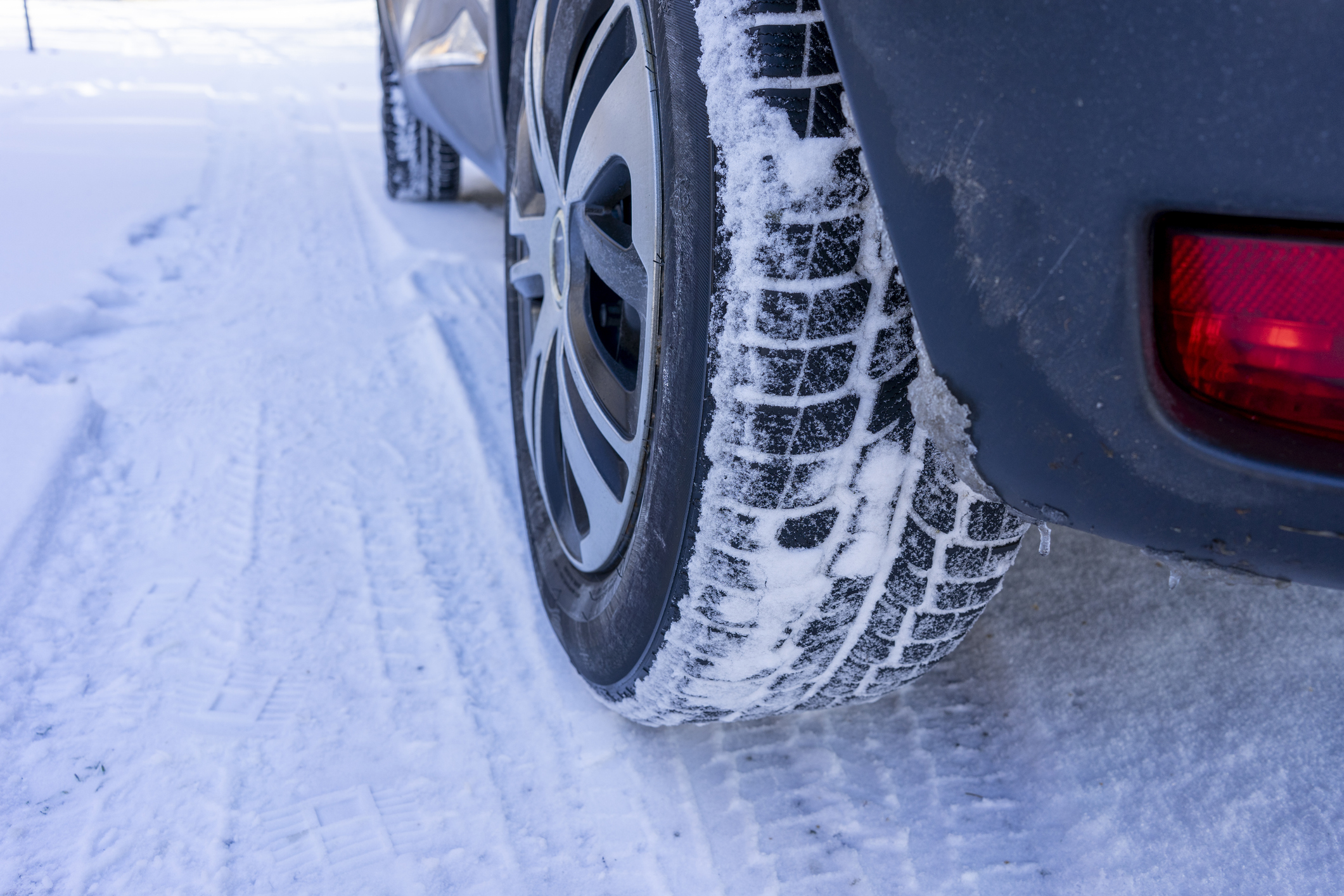 car tires covered in snow on a snowy road in maryland